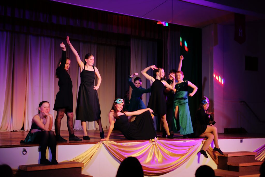 Theatrical performance with dancers in costumes.