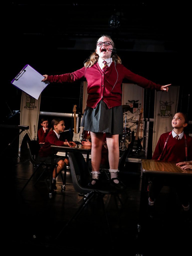 Student performing on a stage.