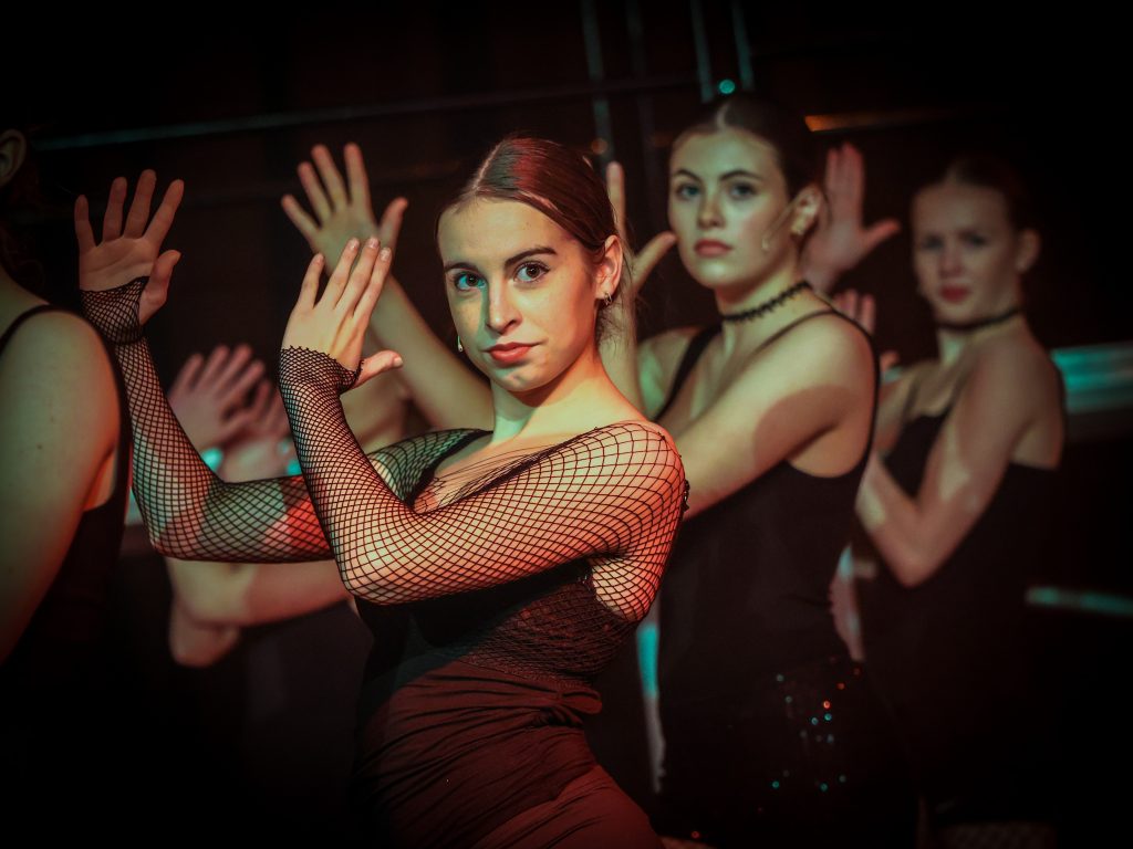 Dancers performing on stage with flair.