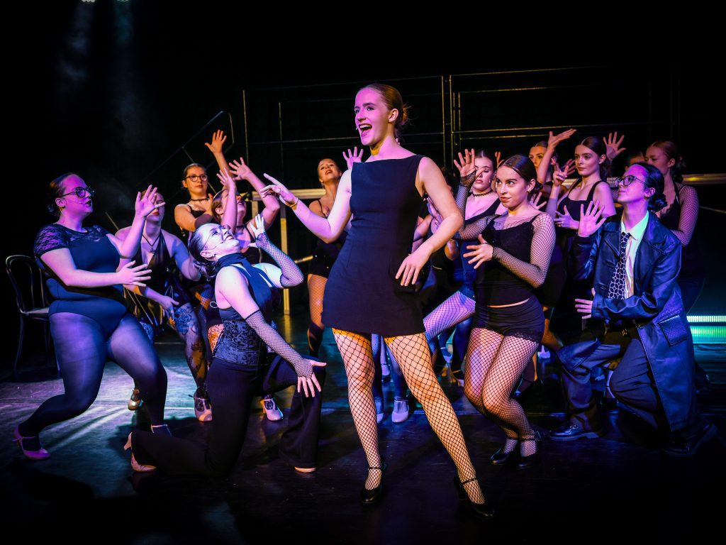 Theatrical performance with dancers and costumes.