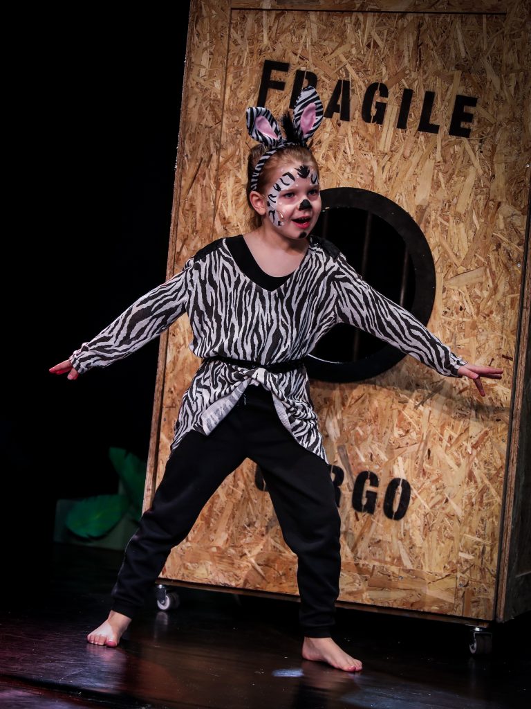 Child in zebra costume performing