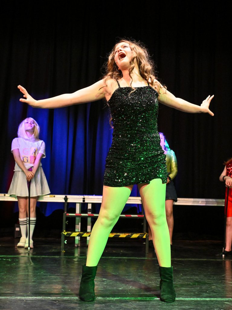 Singer performing on stage passionately