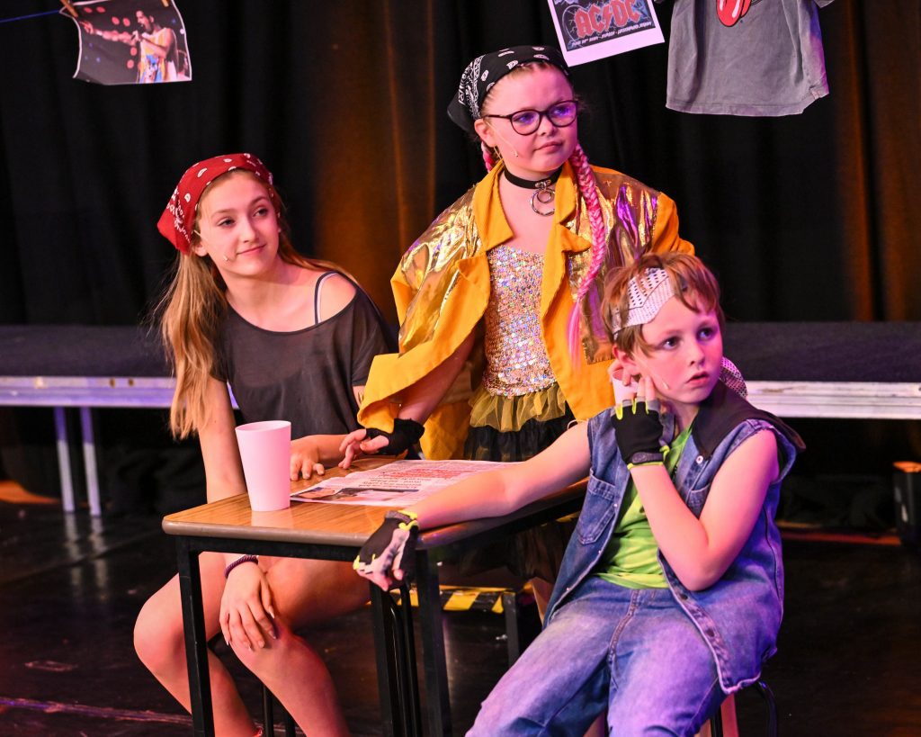 Children performing in colorful costumes